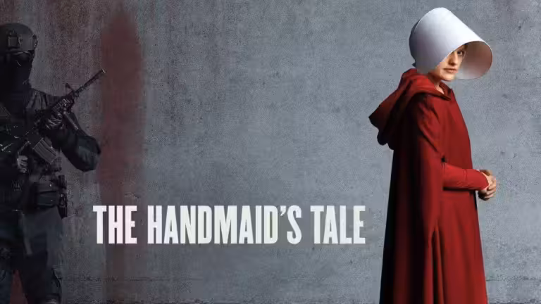 Offred in red Handmaid clothing beside an armed guard in The Handmaid’s Tale